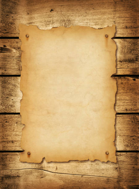 istock Old mediaeval paper sheet. Parchment scroll on a wood board 1438878448