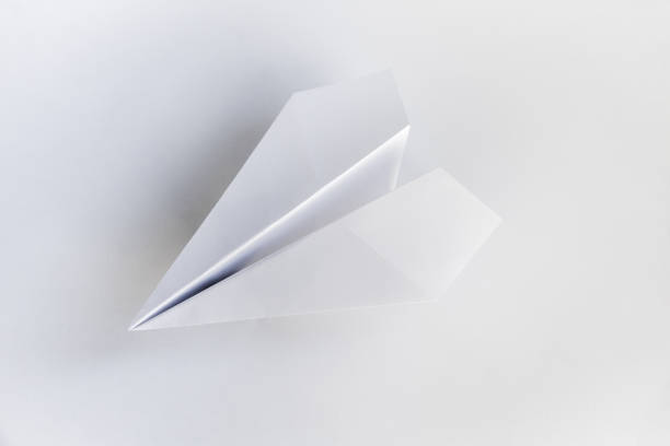 istock Paper plane origami isolated on a white background 1438878484