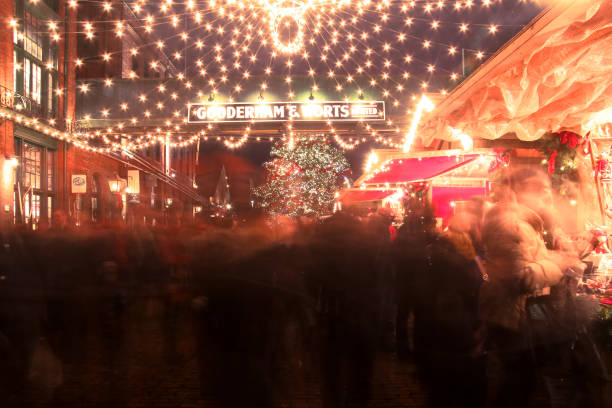 Toronto Christmas Market Toronto, Canada - December 14, 2014: Crowds of people enjoy the festivities at the Toronto Christmas Market (now called the Distillery Winter Village) in Toronto's historic Distillery District. long exposure winter crowd blurred motion stock pictures, royalty-free photos & images