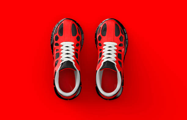 istock A pair of red sneakers isolated on red background. 1438880977