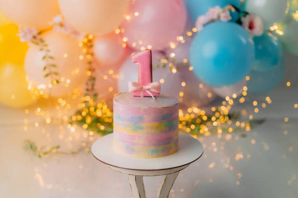 beautiful delicious cake with cream on a wooden stand for a child's birthday. - balão enfeite imagens e fotografias de stock