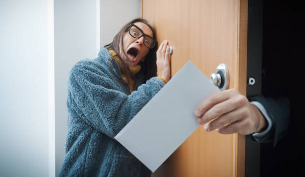 Young woman reading a letter with worried expression