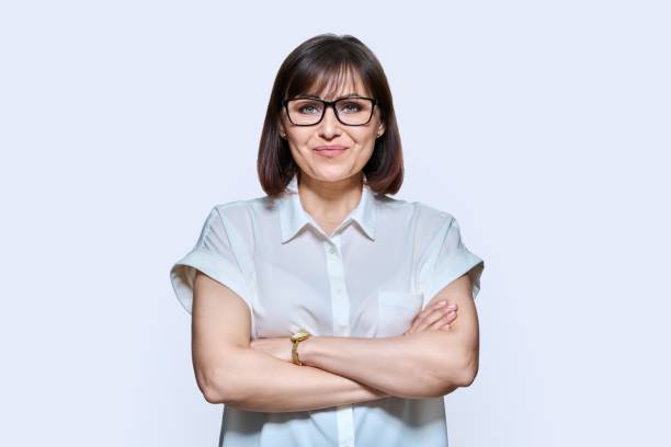 istock Attractive middle aged woman looking at camera on white background 1438882745