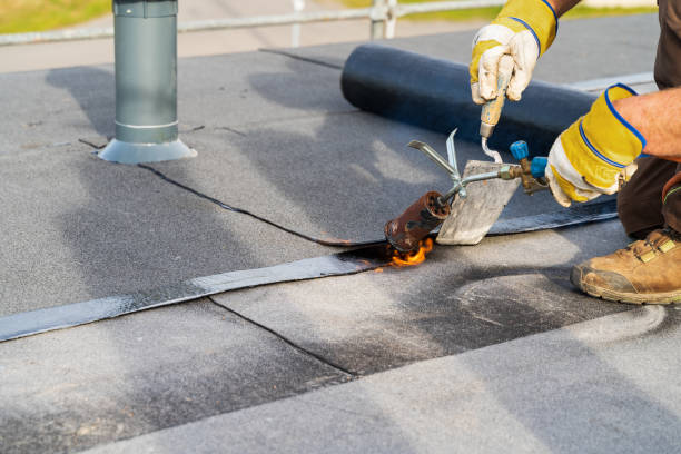 man heating and melting bitumen roofing flat roof installation. - dachdecken imagens e fotografias de stock