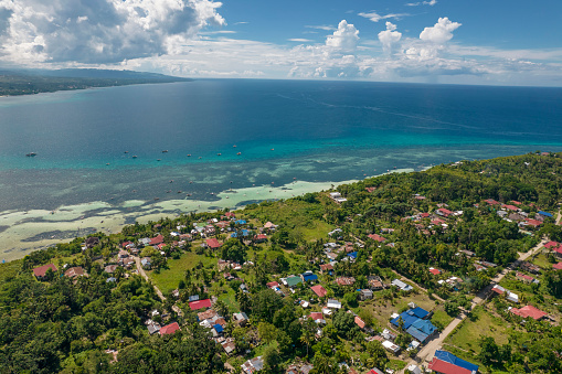 Aerial view of houses near the coast of Dauis. Real estate properties in Panglao Island, Bohol.