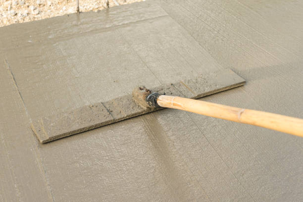 istock Using a bull float to level, even out and flatten the wet concrete. New road and payment construction. 1438886416