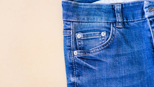istock jeans on the background, blue and black jeans lie on a white background, 1438889117