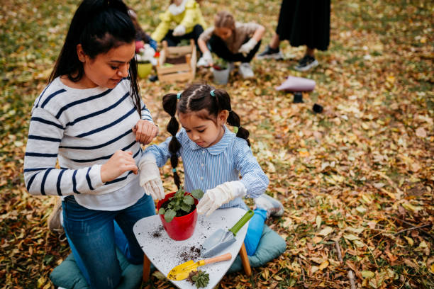 istock Mother and Daughter Planting Seedlings 1438889421