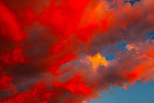 Dramatic red-orange blurred background of the setting sun. Abstract natural background