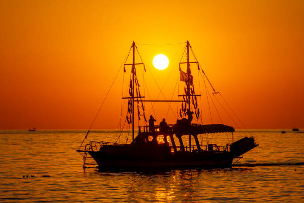 Boat silhouette at scenic sea sunset