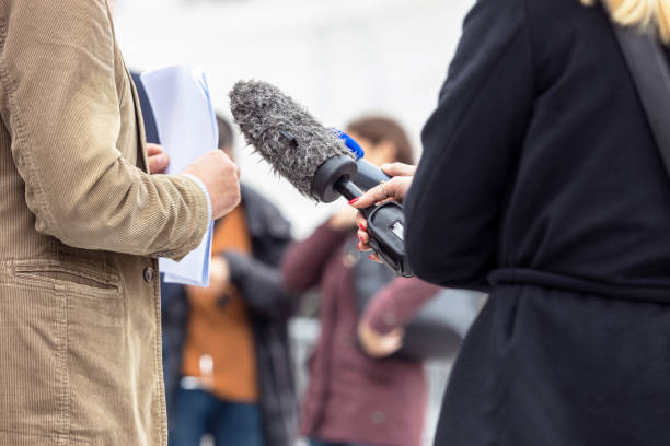 istock Whistleblower holding document and giving statement at media event or news conference 1438893031