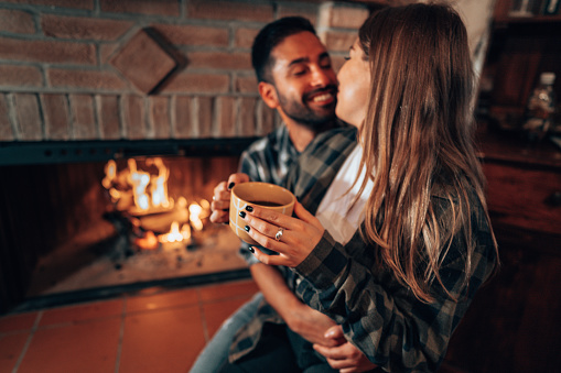 happiness couple take a selfie in front of the fireplace