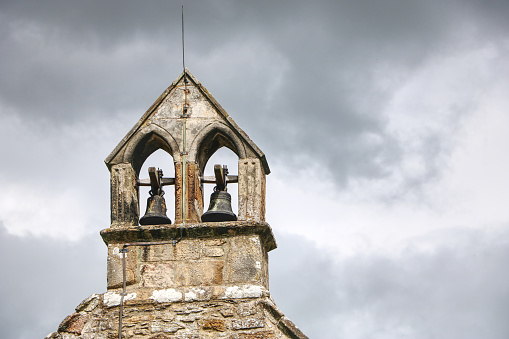 Old church bell tower with a grey sky in the background in north yorkshire