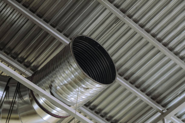 istock Galvanized round ventilation duct in an industrial building. Engineering air system. 1438899271