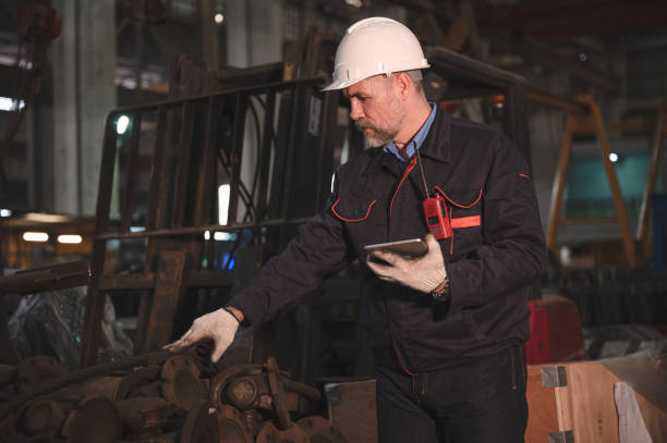 istock Senior caucasian engineer use tablet checking spares in factory spares train 1438899425