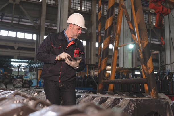 istock Senior caucasian engineer use tablet checking spares in factory spares train 1438899449