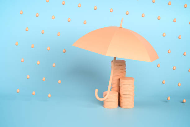 istock Protection or insurance concept: Minimalistic stacks of coins under an open umbrella protecting them against rain. 1438901240