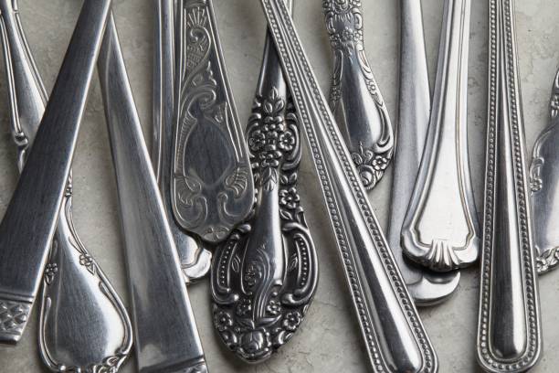 istock Lot of silver forks and spoons with antique patterns on a white surface 1438904593
