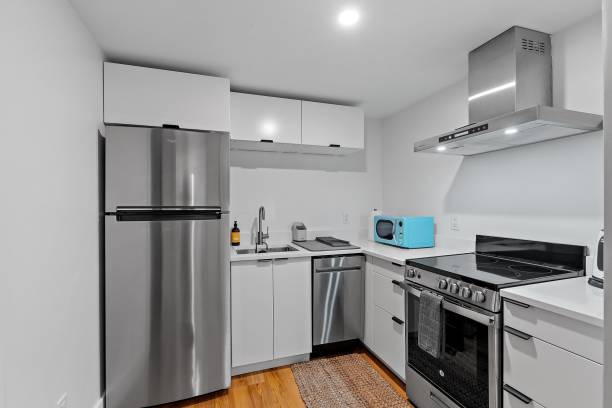 istock Modern kitchen with silver furniture and white walls 1438904601
