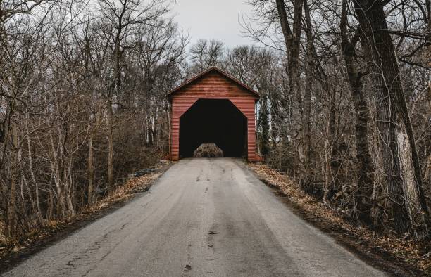 istock Path leading to a small red garage in the forest with bare trees in winter 1438904851