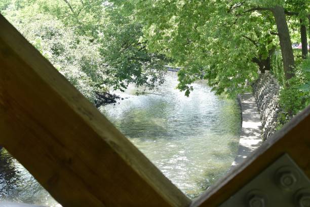istock River surrounded by walls of a park covered in greenery under sunlight in Illinois 1438905018