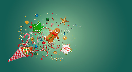 New Year and Christmas concept with Christmas cookies, festive winter decorations and confetti on teal background. Holiday banner.