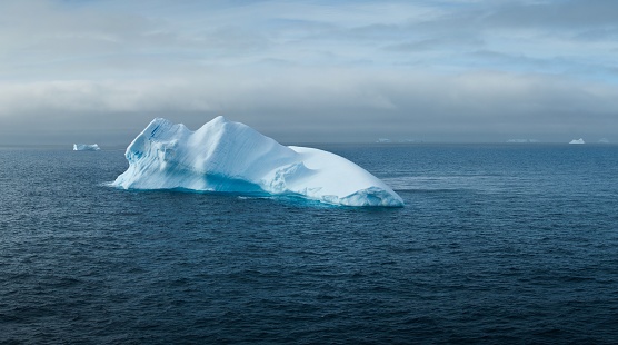 A beautiful shot of a large iceberg in the middle of the sea near Antarctica