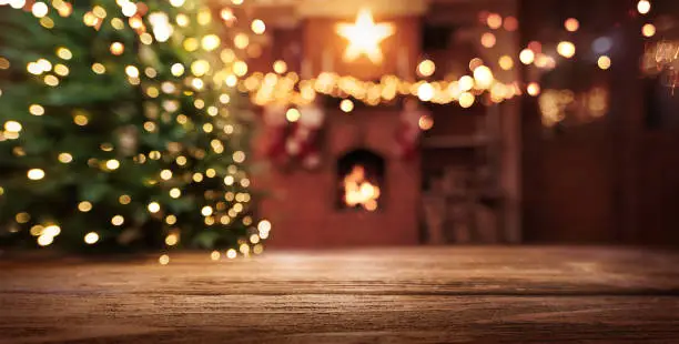 Photo of Christmas Tree With Illumination Near the Fireplace. Home Decor