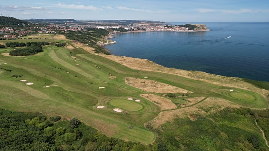 An aerial view of gold course surrounded by water towards Scarborough