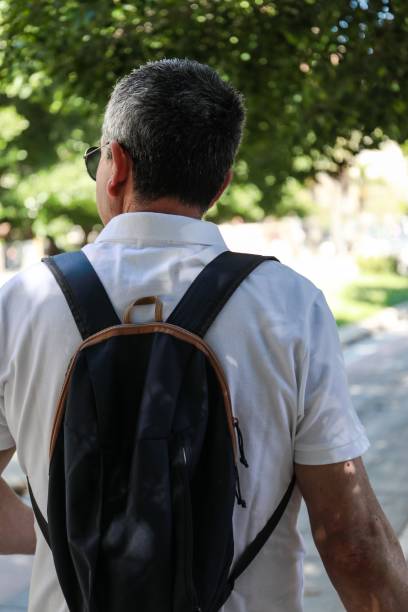 istock Man in white polo and backpack walking in Alicante 1438906786