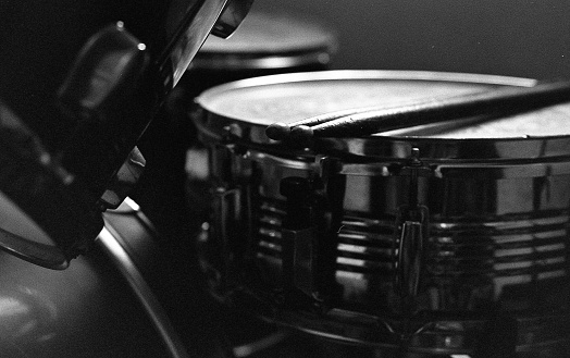 A closeup greyscale shot of drums ready to lead the crowds with art
