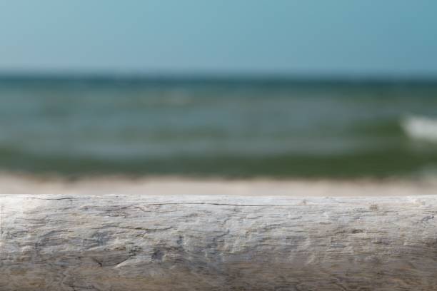 istock Mock-up for product presentation, wooden base and beach backdrop. 1438907125