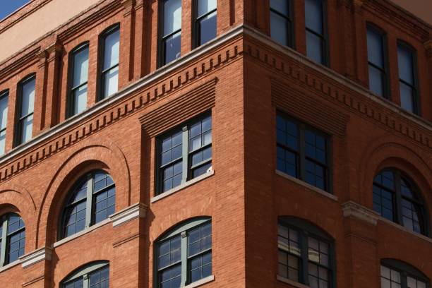 istock Low angle shot of a brick building with arched type windows 1438907377