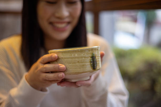 istock Woman holding a cup of Matcha tea 1438907663
