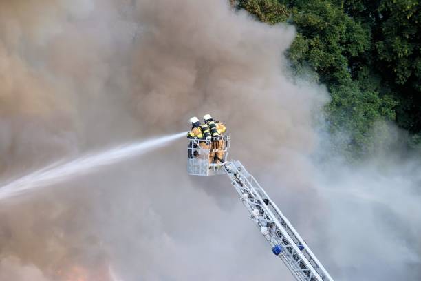 istock Two firefighters trying to stop the fire in the forest surrounded by smoke 1438907857
