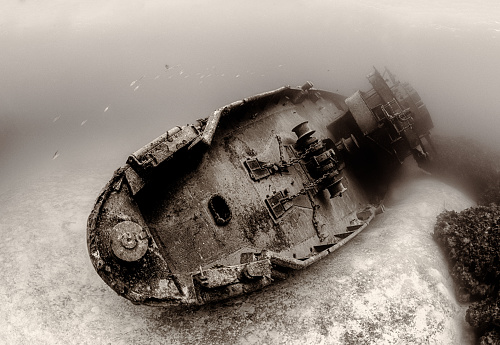 A sepia-toned photograph of the famous sunken USS Kittiwake (ASR-13) in Grand Cayman Island