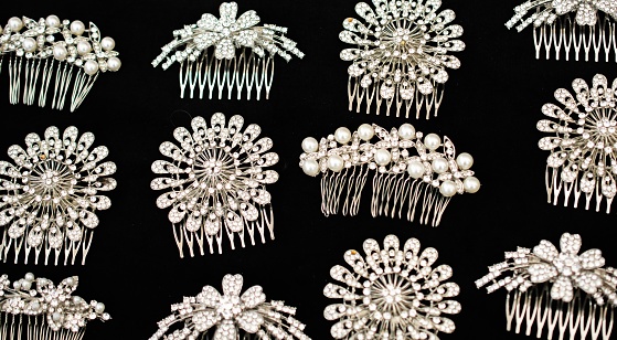 A top view shot ornate bridal hair combs adorned with diamonds and pearls