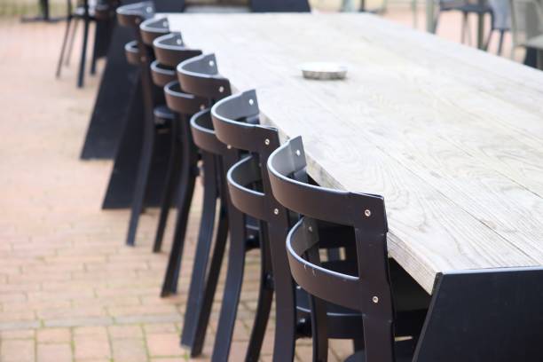 istock Selective focus shot of chairs around a long wooden table 1438909077