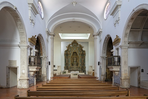 A beautiful chapel in Waterford, Ireland. A beautiful organ and rows of ornate pillars and pews adorn the interior of this sacred space.