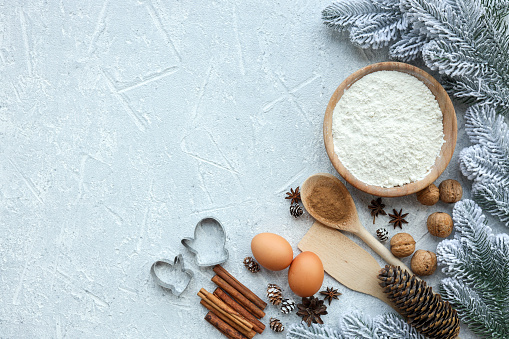 Ingredients for cooking christmas baking. Flour, eggs, brown sugar and spices. Top view with copy space.