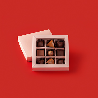 Box of chocolates on a red background.