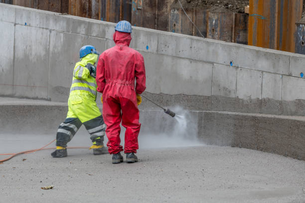 istock Workers clean concrete wall with high-pressure cleaner 1438917934