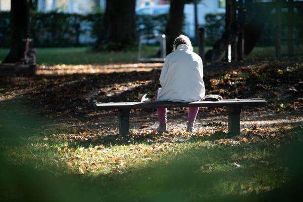 istock Old man on park bench in the sunshine 1438918368