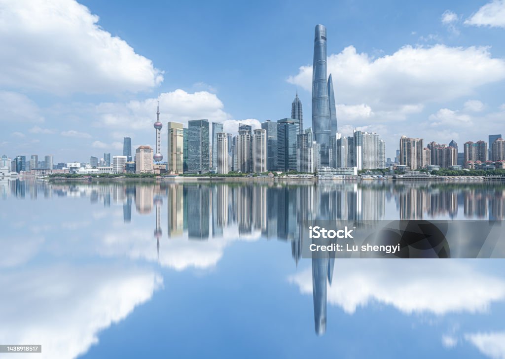 skyline of Shanghai financial district buildings, and Huangpu river in the day shanghai skyline in the day, showing the Huangpu river with passing cargo ships, financial district and cloudy sky background Shanghai Tower - Shanghai Stock Photo