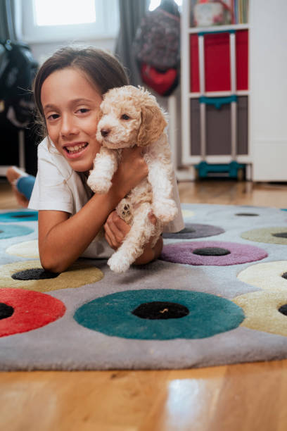 istock Cute girl embracing her new pet 1438920217