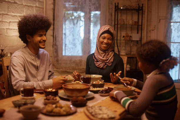 istock Happy Middle Eastern family enjoying in meal at dining table. 1438924009