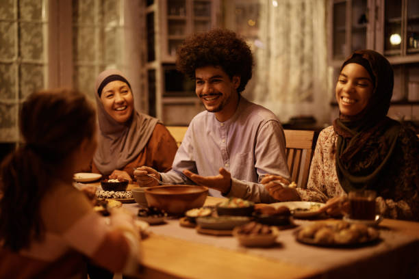istock Happy Middle Eastern family enjoying in conversation during Ramadan meal at dining table. 1438924197