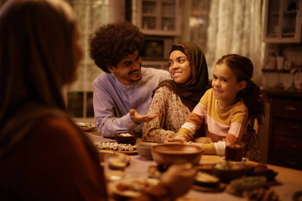 istock Happy Middle Eastern family talking at dining table. 1438924198