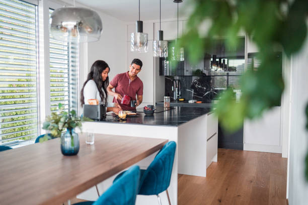 istock Good Looking Young Multi-Ethnic Couple Preparing Breakfast Together 1438924272