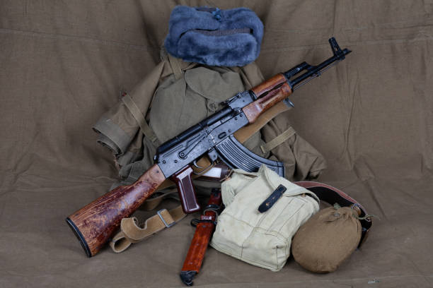 istock Mobilization in russia 2022. Kalashnikov gun with primitive WW2 pattern soviet army equipment. 1438926592